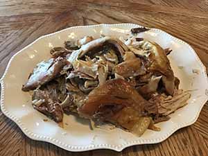 neighbors gather at for Thanksgiving Day potluck dinner