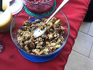 neighbors gather at for Thanksgiving Day potluck dinner