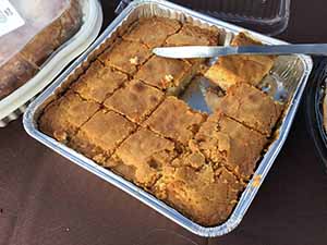 neighbors gather at for Thanksgiving Day potluck dinner
