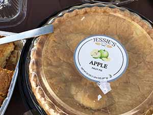 neighbors gather at for Thanksgiving Day potluck dinner