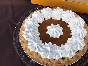 neighbors gather at for Thanksgiving Day potluck dinner