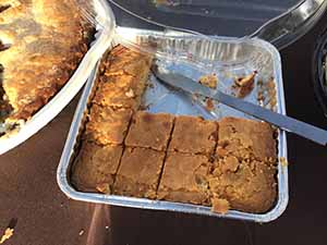 neighbors gather at for Thanksgiving Day potluck dinner