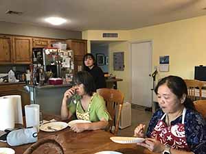 neighbors gather at for Thanksgiving Day potluck dinner