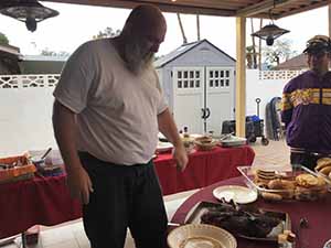 neighbors gather at for Thanksgiving Day potluck dinner
