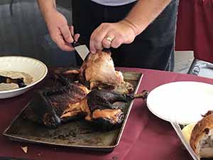 neighbors gather at for Thanksgiving Day potluck dinner