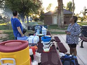 neighbors gather at park for potluck dinner birthday party