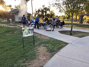 neighbors gather at park for potluck dinner birthday party
