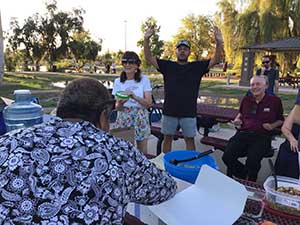 neighbors gather at park for potluck dinner birthday party