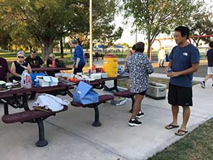 neighbors gather at park for potluck dinner birthday party
