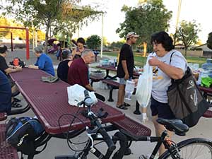 neighbors gather at park for potluck dinner birthday party