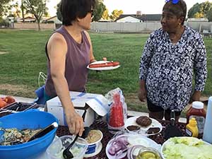 neighbors gather at park for potluck dinner birthday party