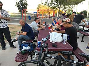 neighbors gather at park for potluck dinner birthday party