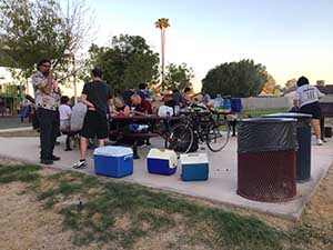 neighbors gather at park for potluck dinner birthday party