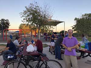 neighbors gather at park for potluck dinner birthday party