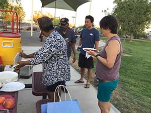 neighbors gather at park for potluck dinner birthday party