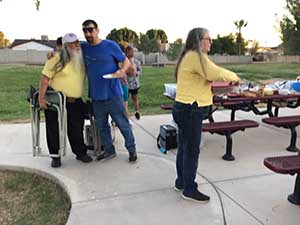 neighbors gather at park for potluck dinner birthday party