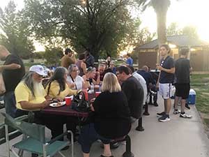 neighbors gather at park for potluck dinner birthday party