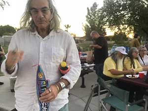 neighbors gather at park for potluck dinner birthday party