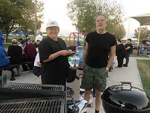 neighbors gather at park for potluck dinner birthday party