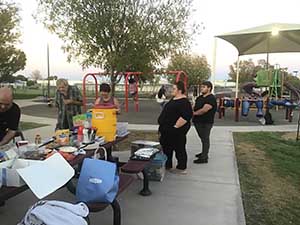 neighbors gather at park for potluck dinner birthday party