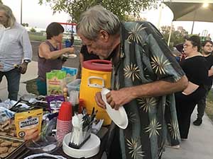 neighbors gather at park for potluck dinner birthday party