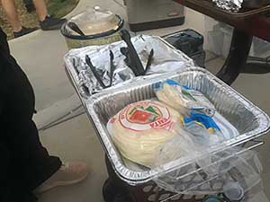 neighbors gather at park for potluck dinner birthday party