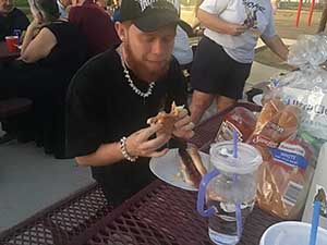 neighbors gather at park for potluck dinner birthday party