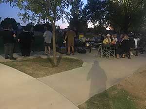 neighbors gather at park for potluck dinner birthday party