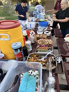 neighbors gather at park for potluck dinner birthday party