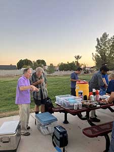 neighbors gather at park for potluck dinner birthday party