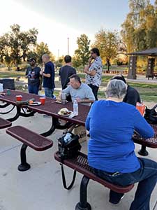 neighbors gather at park for potluck dinner birthday party