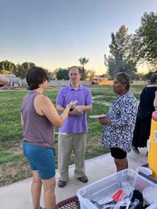 neighbors gather at park for potluck dinner birthday party