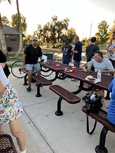 neighbors gather at park for potluck dinner birthday party