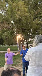 neighbors gather at park for potluck dinner birthday party
