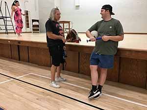 neighbors gather to play indoor volleyball