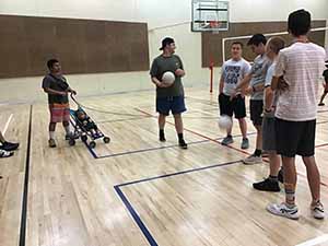 neighbors gather to play indoor volleyball