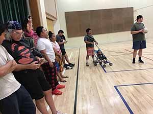 neighbors gather to play indoor volleyball