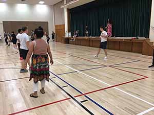 neighbors gather to play indoor volleyball