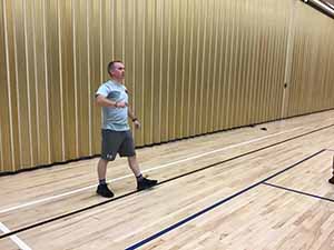 neighbors gather to play indoor volleyball