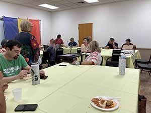 Tempe area neighbors at potluck dinner celebrating Romania